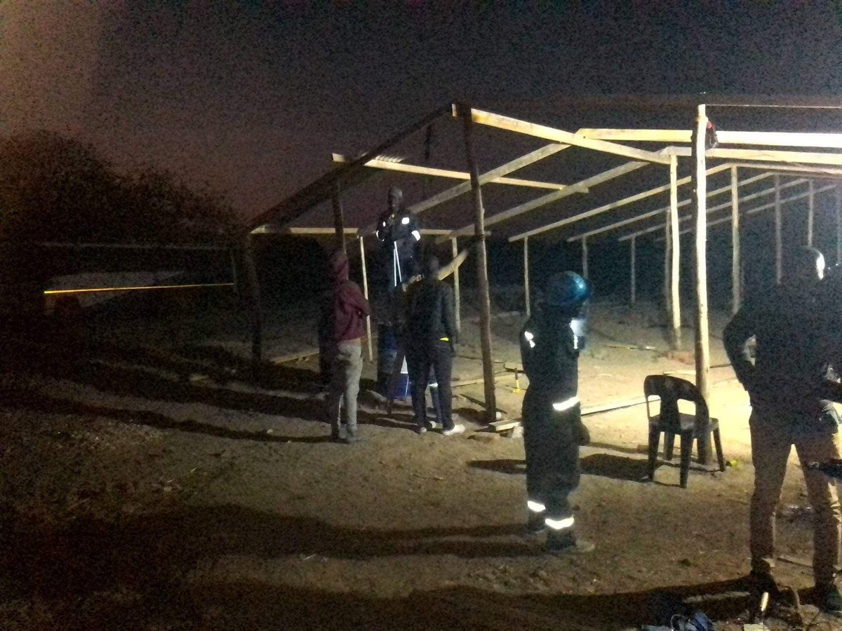 Wooden roof framing for the Karoi church under construction at night