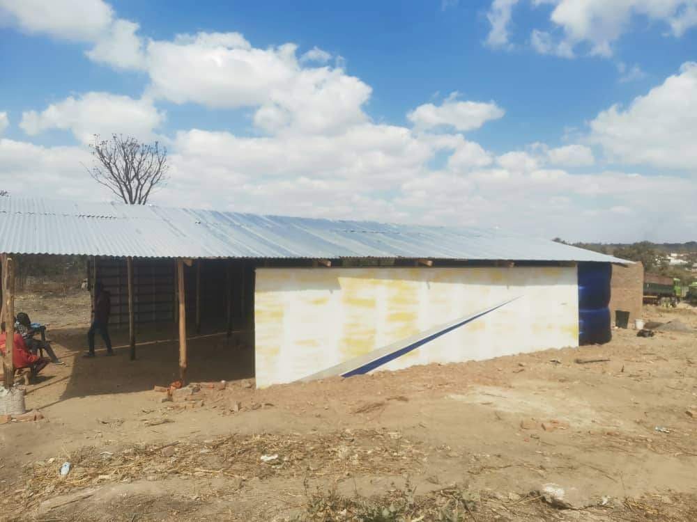 Completed Karoi church building with white walls and a solar panel on the roof