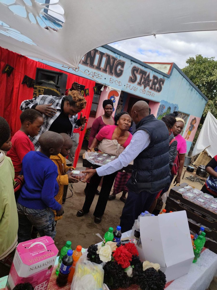NFM volunteers serving food at the Shining Stars day care center